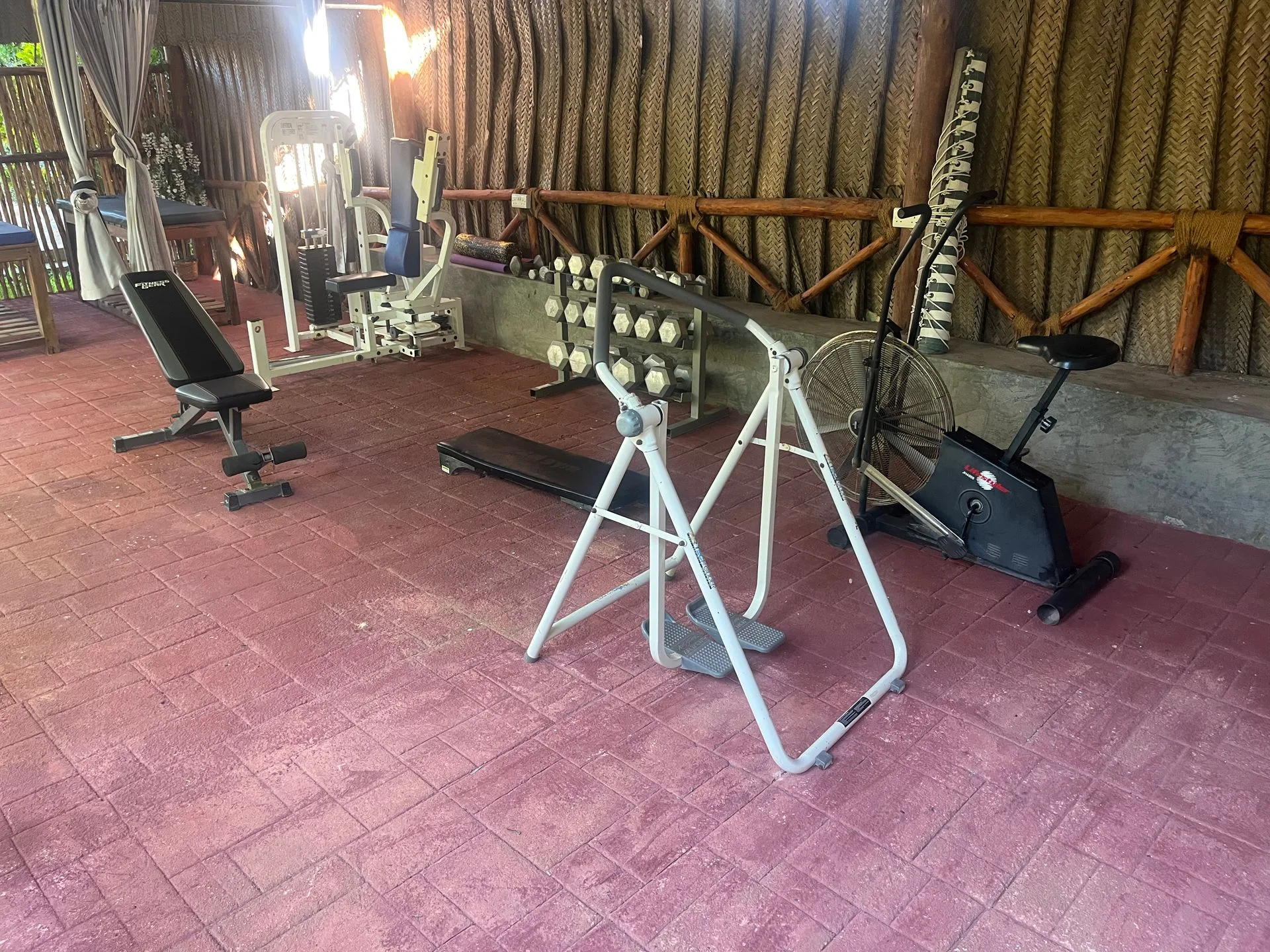 Open-air gym with equipment under thatched roof at Hamia Zanzibar