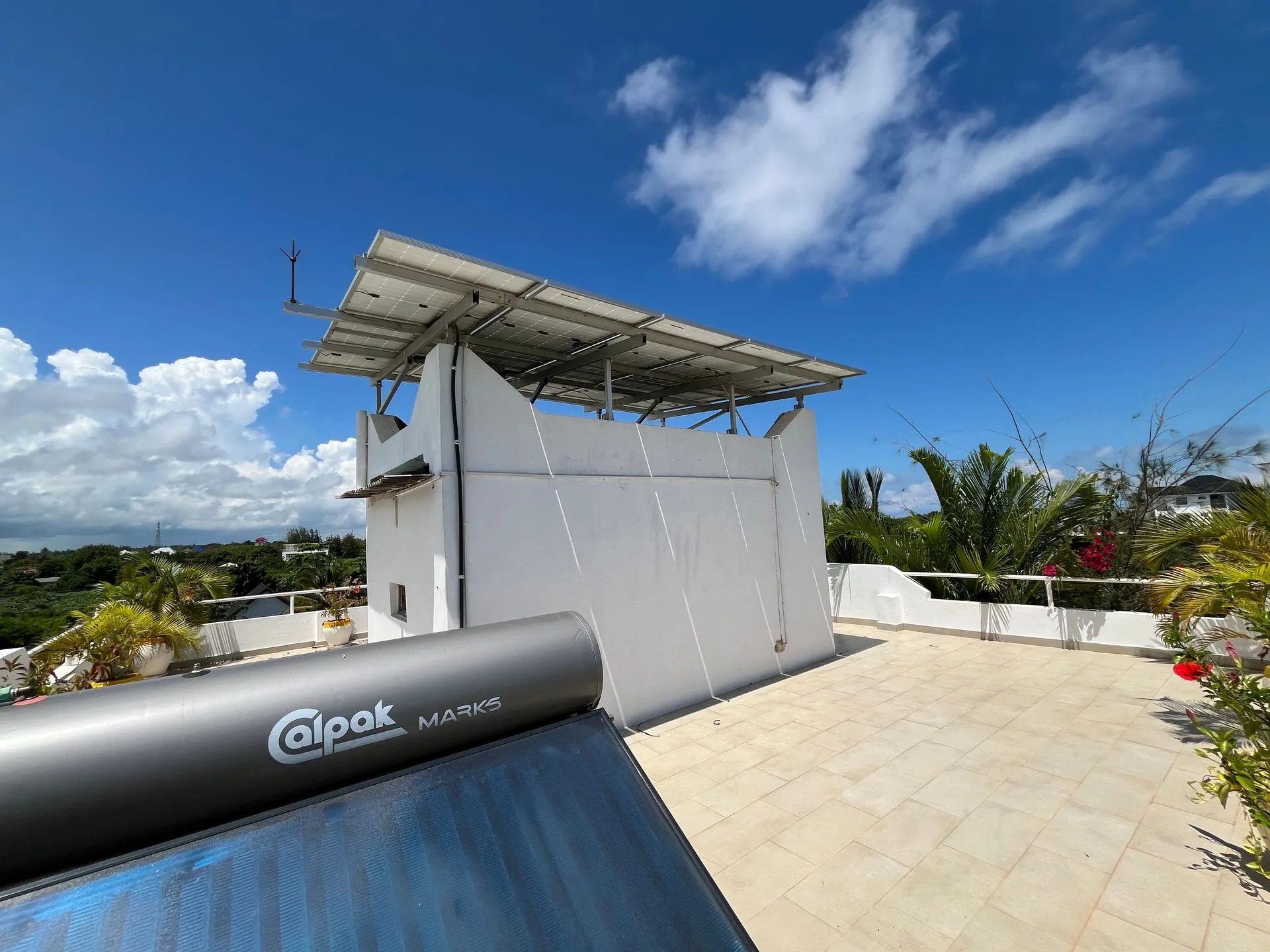 Rooftop terrace at Hamia Zanzibar with solar panels, a Calpak solar water heater and sweeping views over the tropical gardens