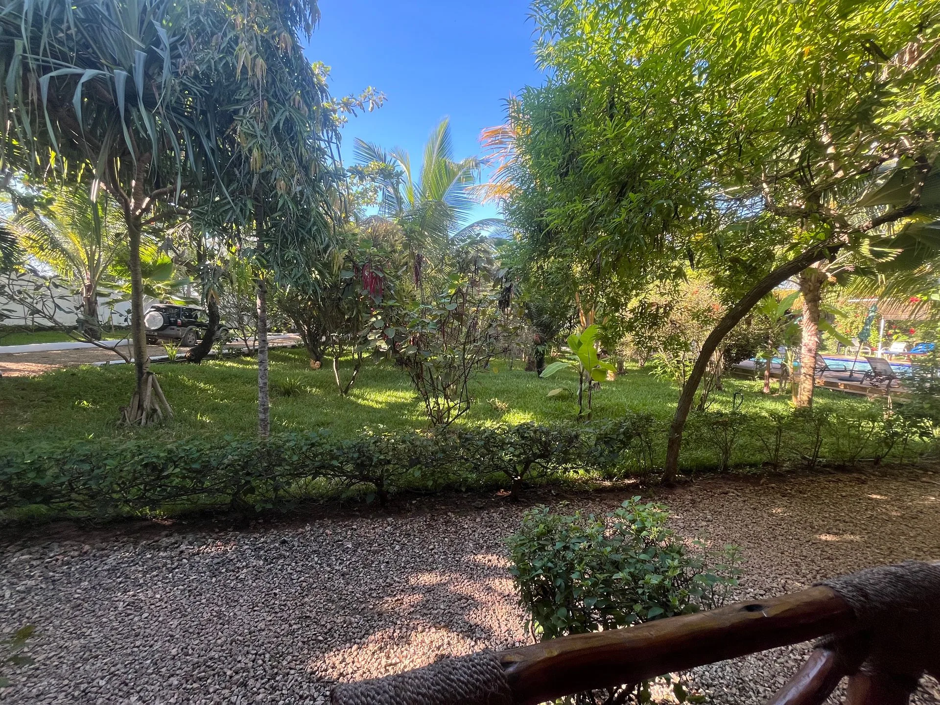 Lush manicured lawn and tropical trees in the private gardens at Hamia Zanzibar