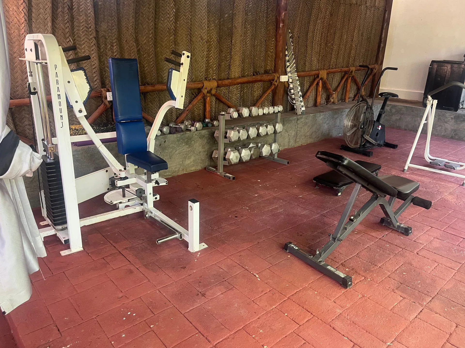 Open-air gym at Hamia Zanzibar with weight machines, free weights and an exercise bike